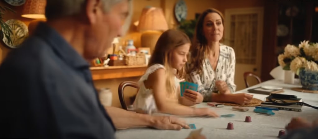 michael middleton, princess charlotte and princess kate playing a game at home