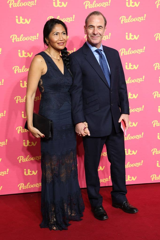 Woman and man holding hands on red carpet