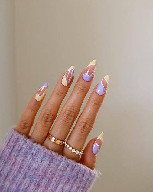 Abstract wave manicure featuring organic swirling lines in sage green, cream, and dusty rose pastel tones