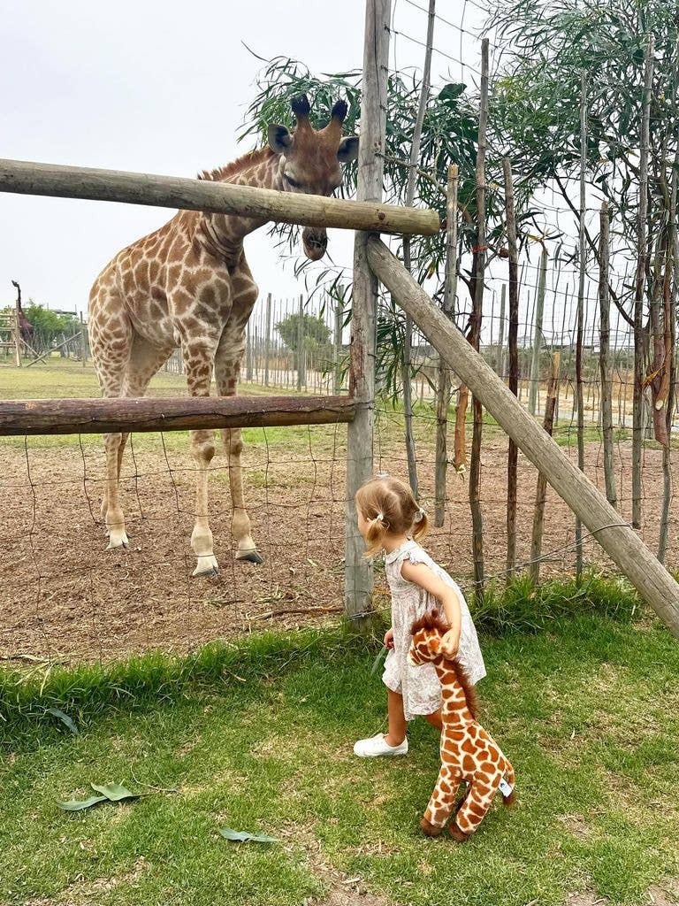 Athena standing beside giraffe