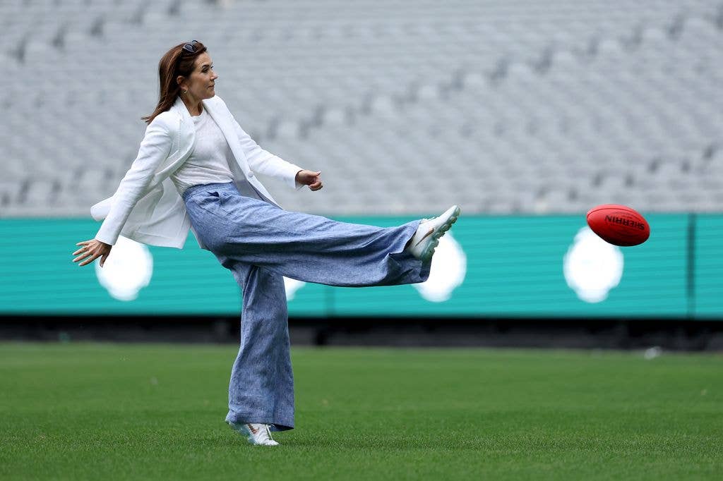 Queen Mary of Denmark kicked a ball during a visit to the Melbourne Cricket Ground 
