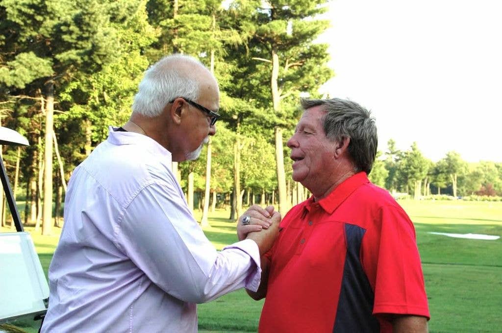 René Angélil and Rodger Brulotte embrace while playing golf, shared by Celine Dion on Instagram