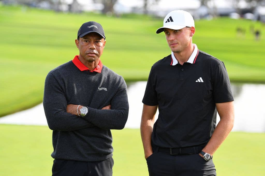 tiger woods arms crossed on golfing green