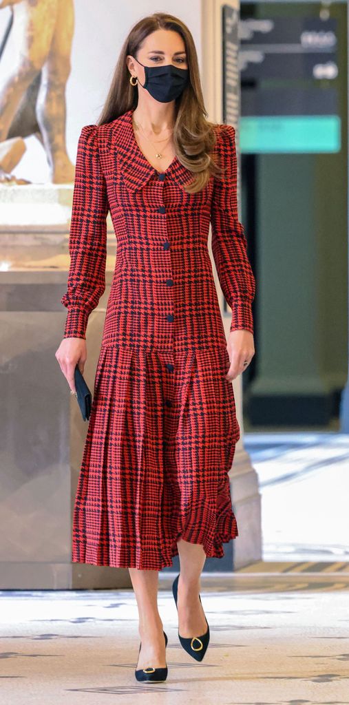Kate in red houndstooth dress and black face mask
