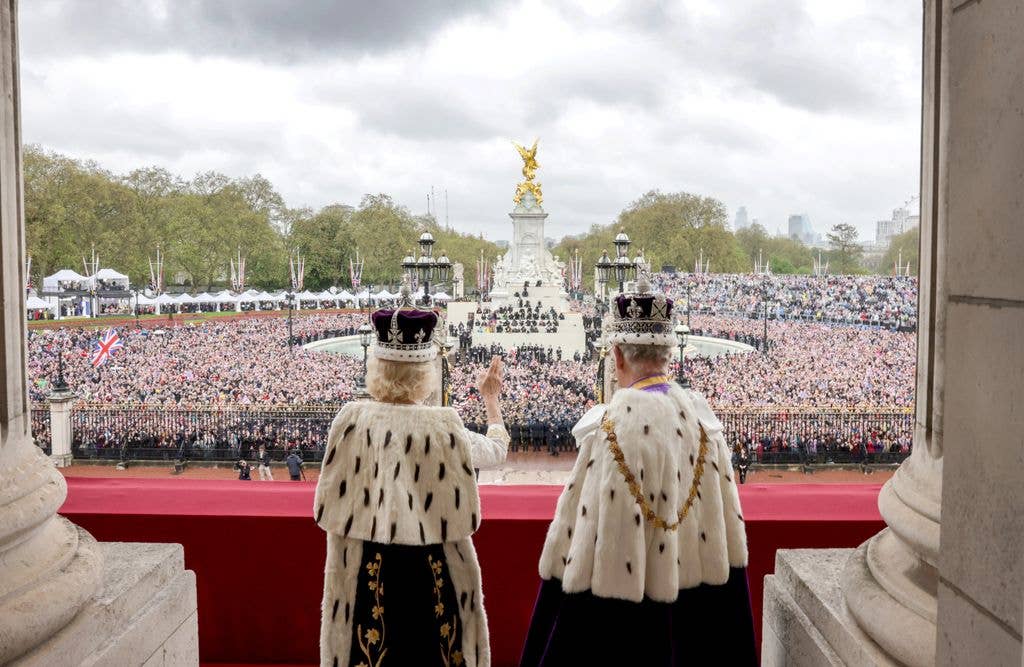 King Charles III and Queen Camilla wave from the balcony of Buckingham Palace after their Coronation