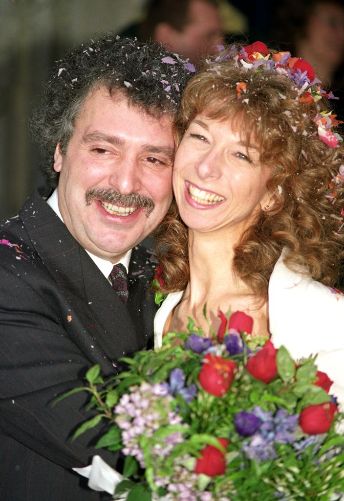 Michael Angelis and Helen Worth embracing and smiling on their wedding day