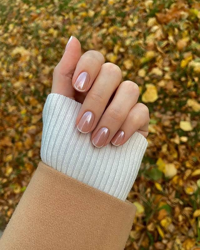 A minimalist Micro-French manicure on short nails featuring a super-fine, delicate white tip and nude base.