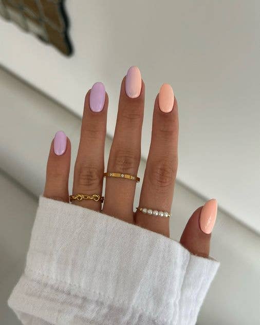 Pastel gradient ombré nails transitioning from soft salmon to lavender across the fingertips