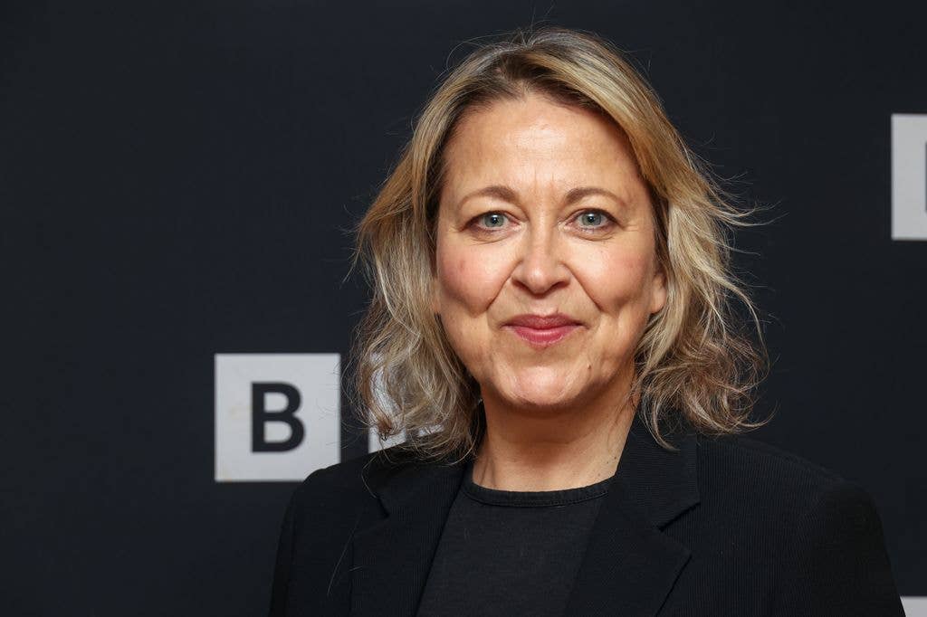 close-up of blonde woman smiling at photo call