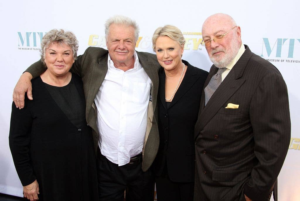 Tyne Daly, John Karlen, Sharon Gless and her husbad Barney Rosenzweig stand next to one another. John Karlen holds his arms around Tyne and Sharon's shoulders.