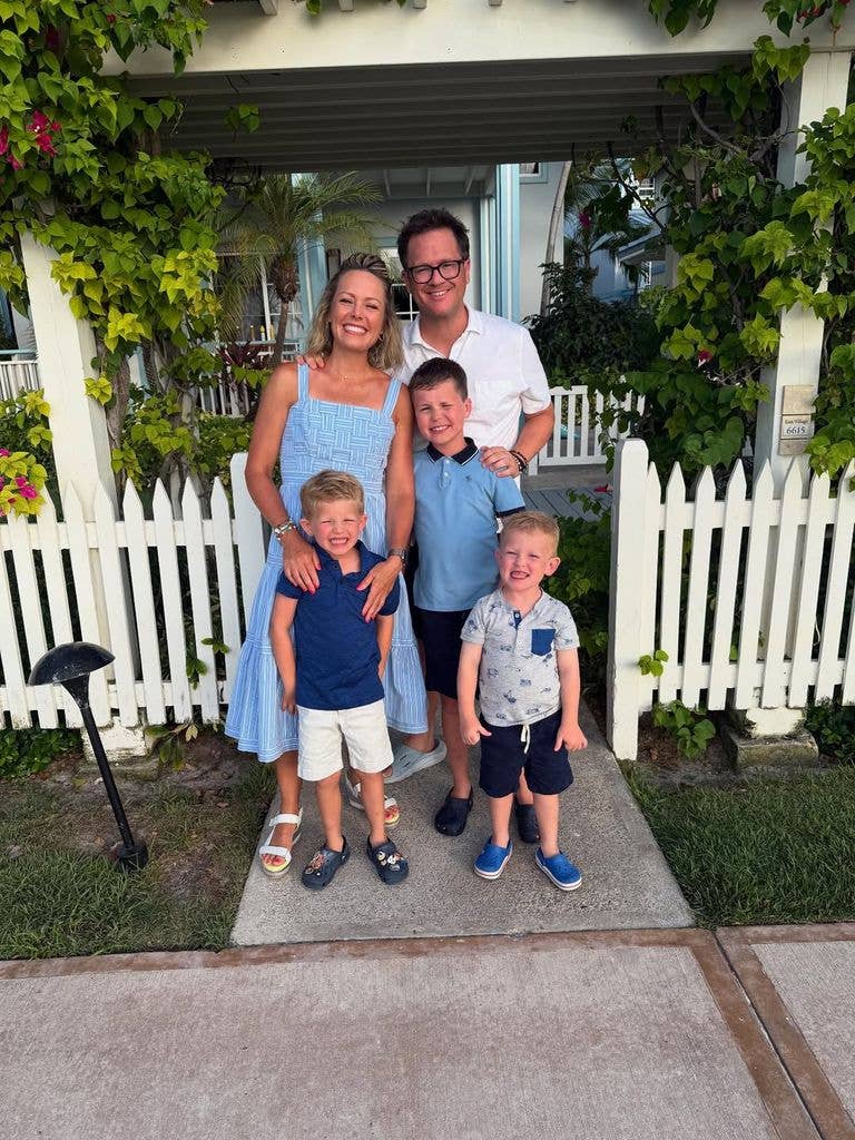 Dylan Dreyer and Brian Fichera pose for a photo beside a white picket fence with their three sons, shared on Instagram