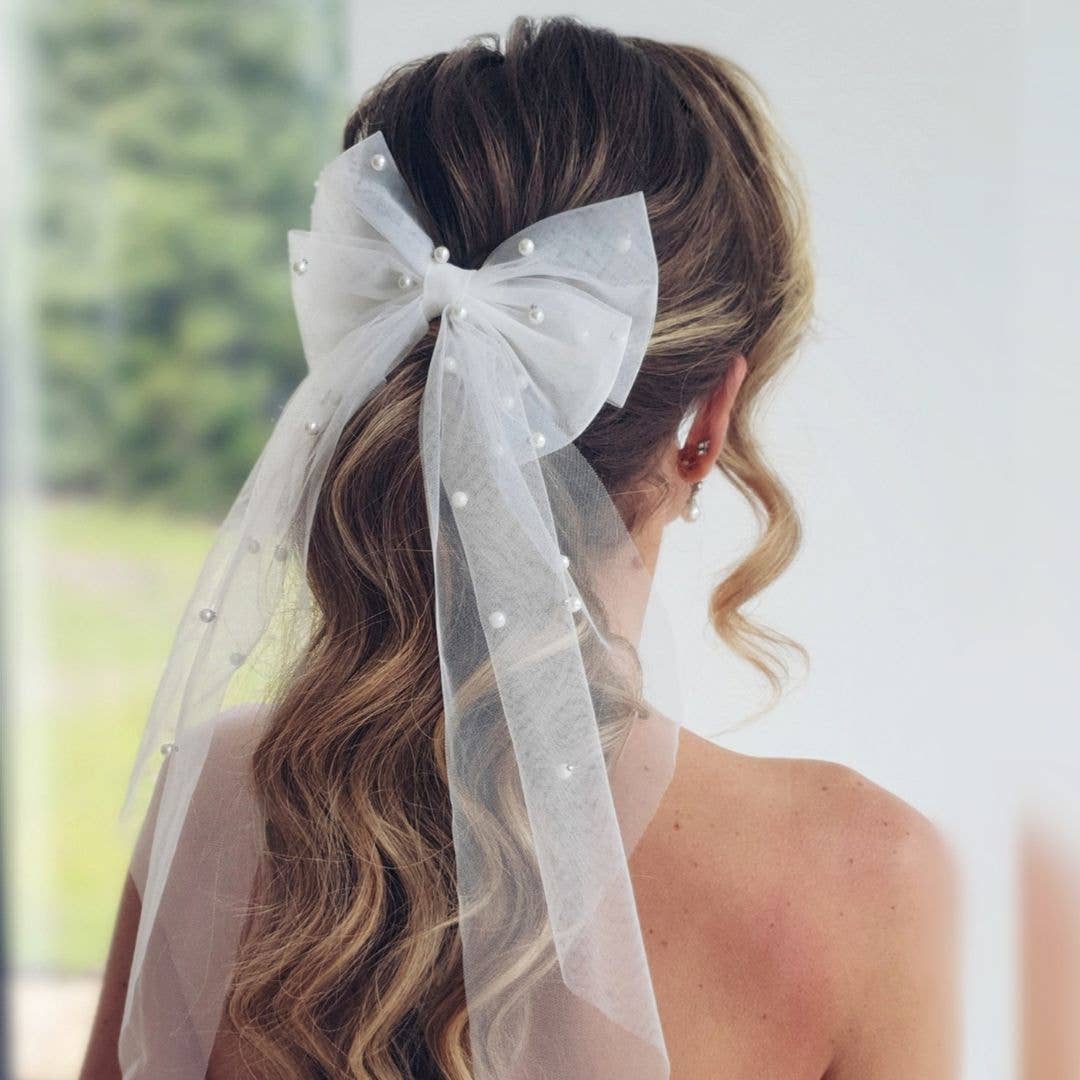 Woman with a pearl-encrusted bow in her hair