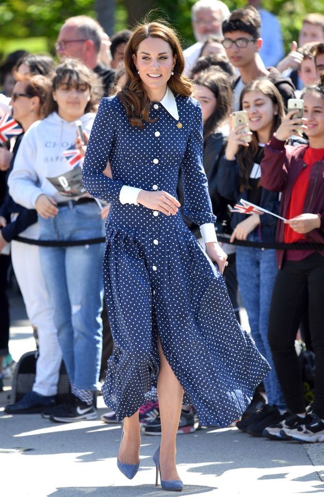 Kate outside in navy polka dot dress