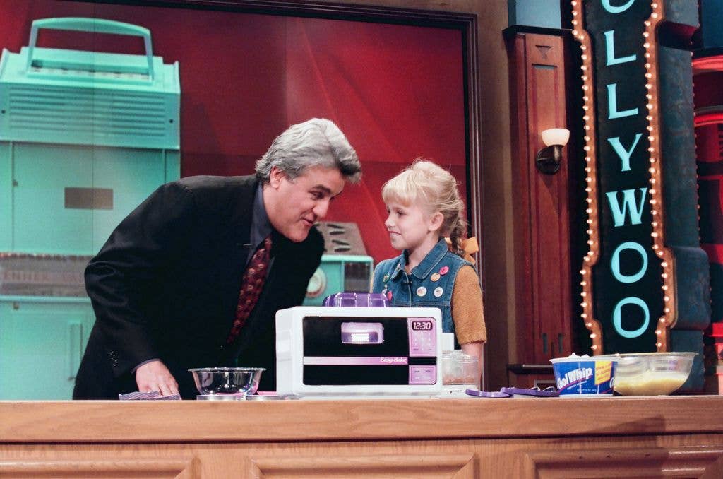 Jay Leno stands over an Easy Bake oven with guest Lindsey Thompson.