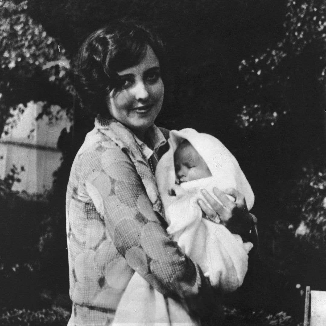 1932:  Actress Elizabeth Taylor as a baby in the arms of her mother, Sara Taylor (1896 - 1994).
