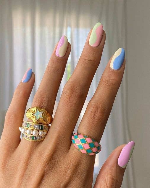 Two-tone wavy nail art design splitting each nail with contrasting pastel blue and lemon yellow polish