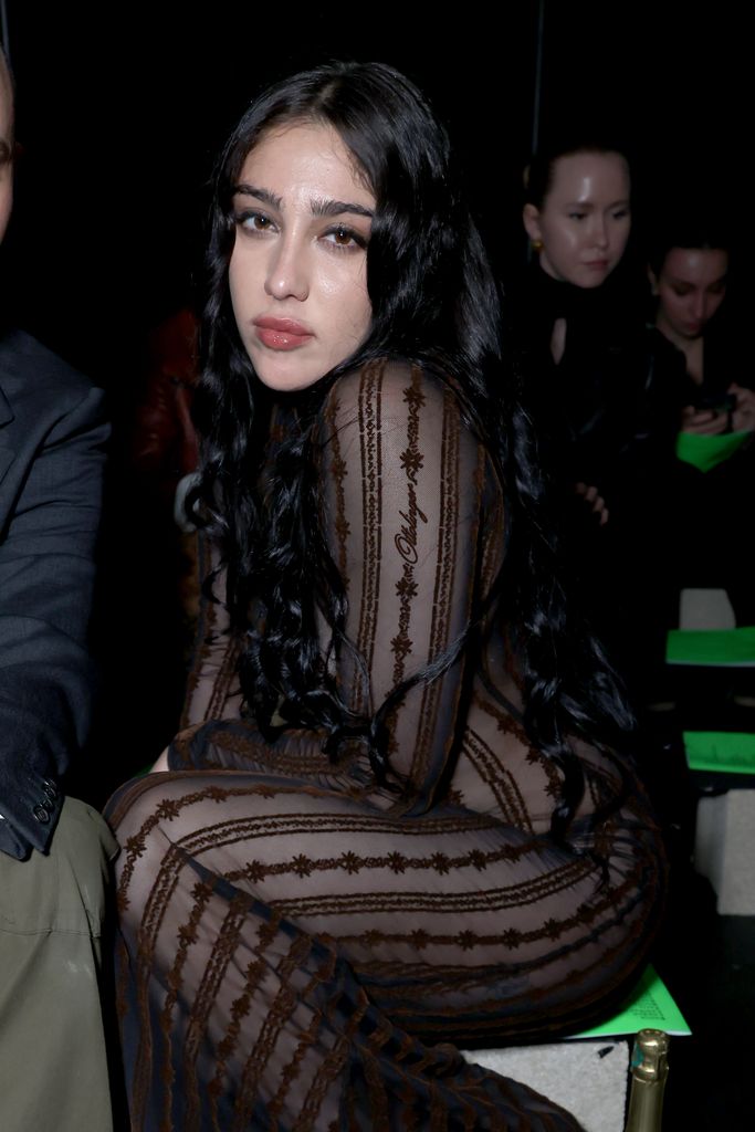 Lourdes in a sheer black dress