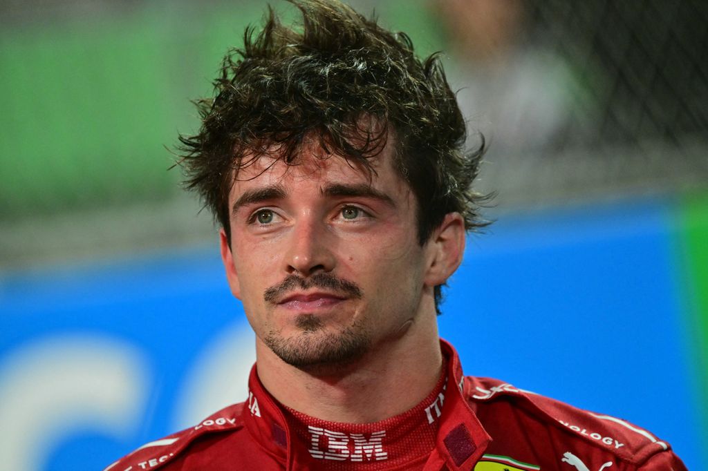 Charles Leclerc with messy hair in a Ferrari race suit