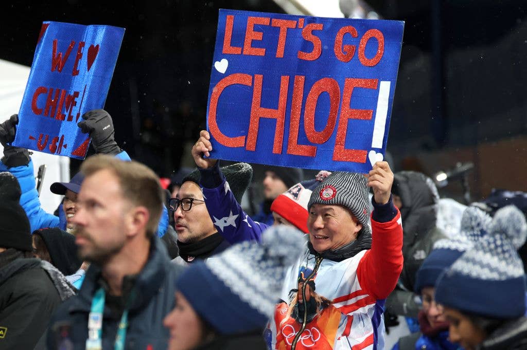 Jong Jin Kim, Father of Chloe Kim of Team United States, holds a sign in support of his daughter as he watches the Womenâs Snowboard Halfpipe Final on day six of the Milano Cortina 2026 Winter Olympic games at Livigno Snow Park on February 12, 2026 in Livigno, Italy