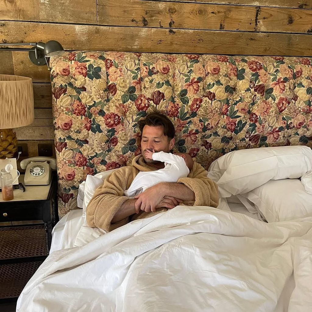 Mark Wright holds his newborn daughter 