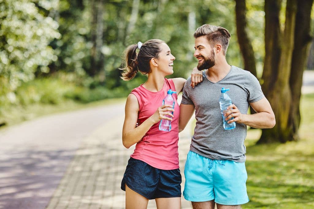 couple mirroring each other while running.