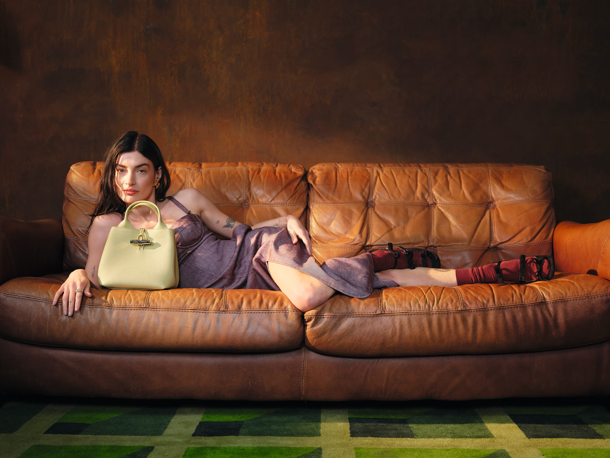 sydney lima on the sofa with longchamp bag