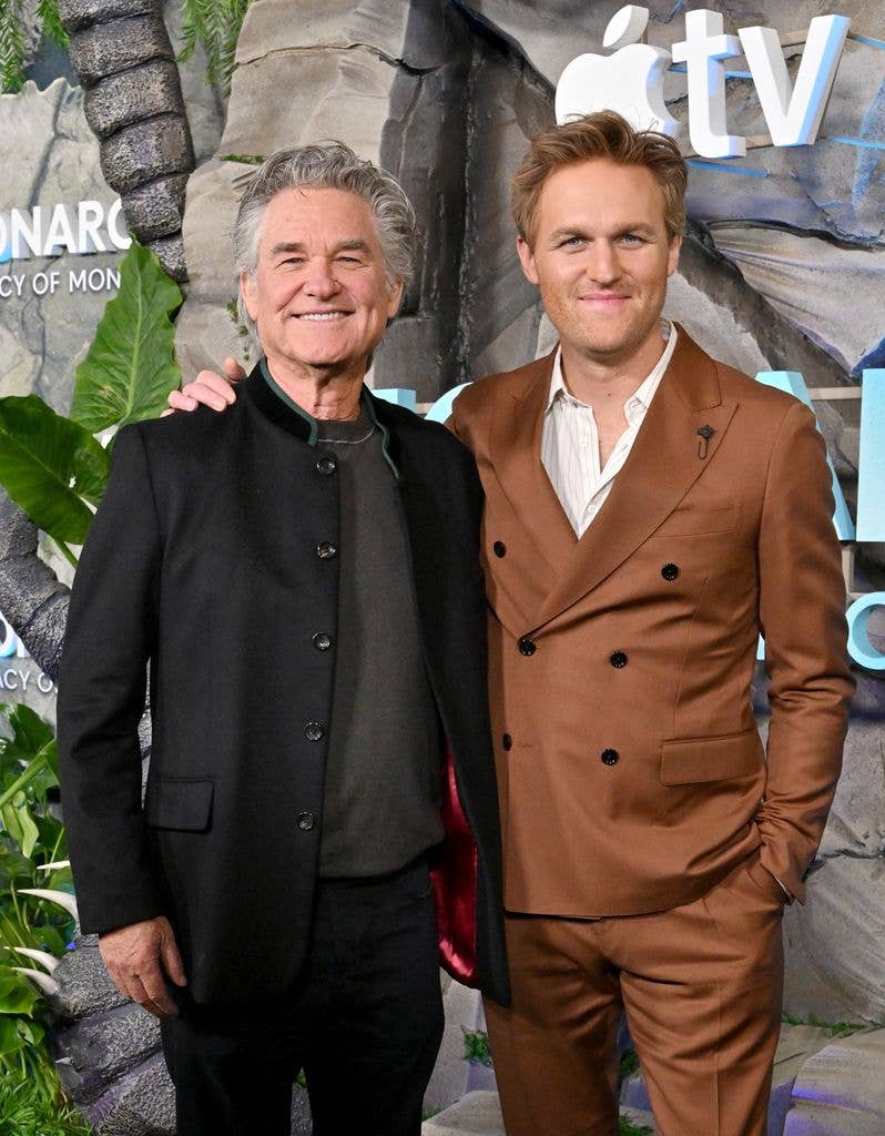 photo of wyatt russell with stubble and shorter hair with arm around kurt russell
