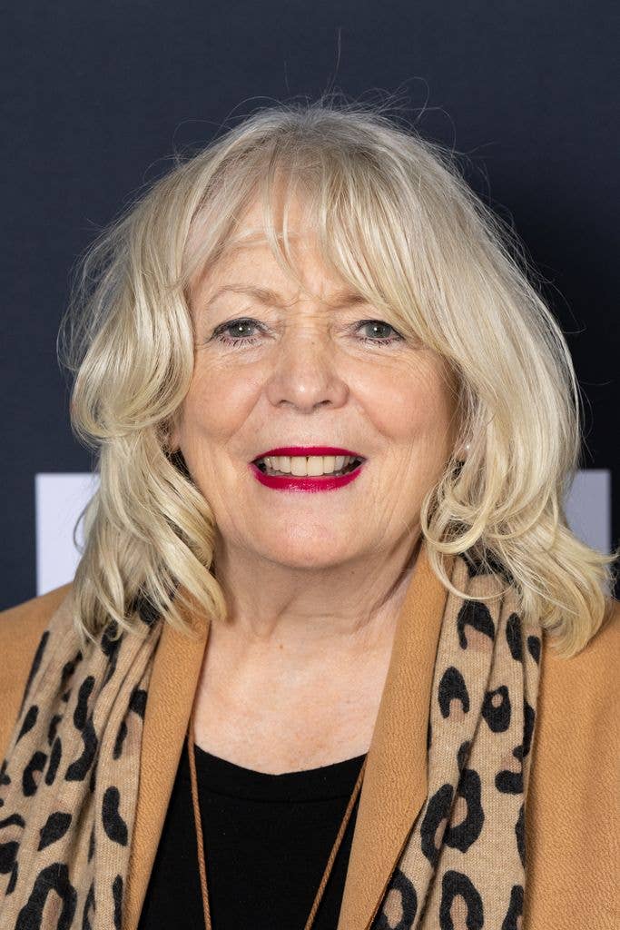 Alison Steadman in a tan coat and leopard-print scarf