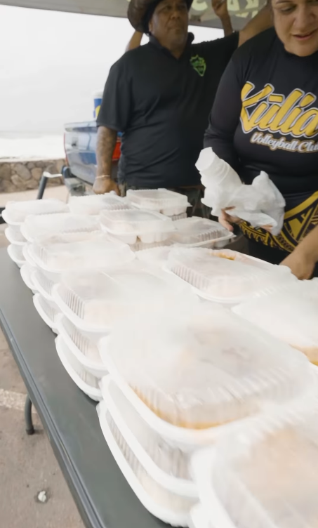 Volunteers serving meals to those affected by the floods