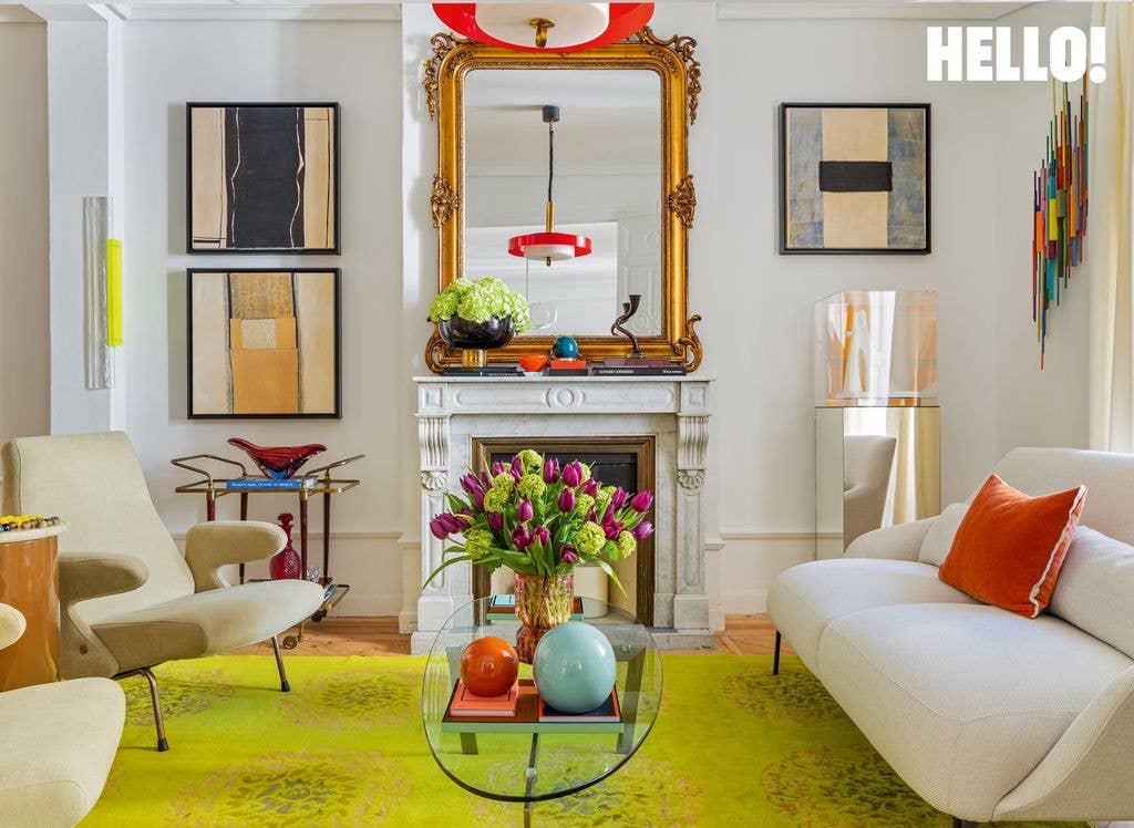 A fireplace in the living room of designer Silvia Tcherassi’s Madrid home features an antique mirror, a 1950s Italian chair, a glass coffee table, and a lime-green patterned carpet