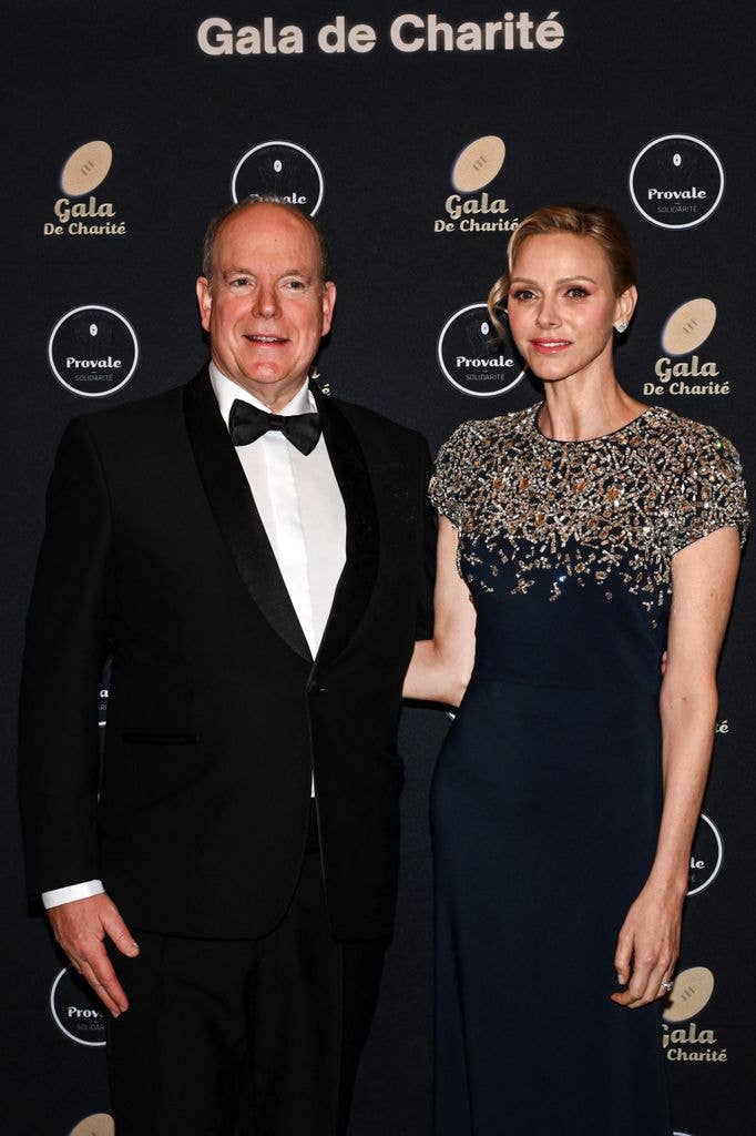 Princess Charlene in gown featuring intricate jewel embellishments on the top alongside albert in suit