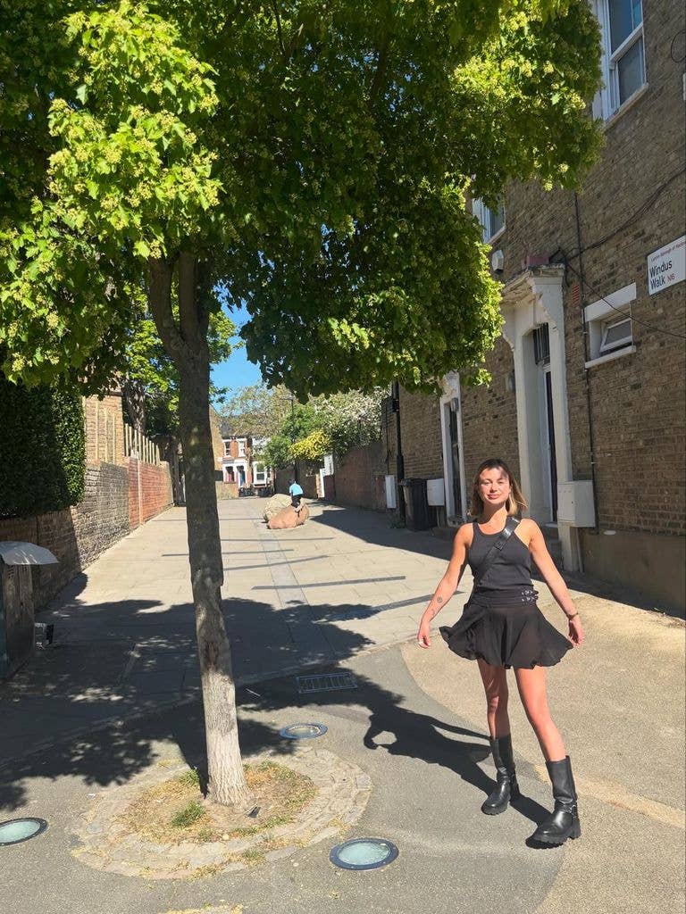A photo of Lady Amelia Windsor wearing a black skirt and boots