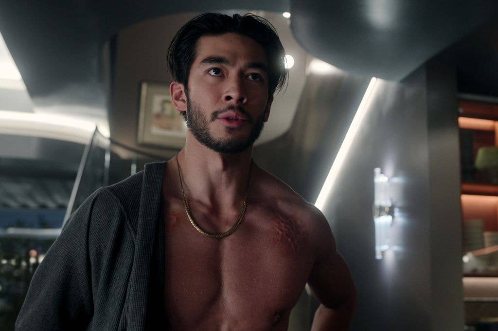 Justin Chien with an open shirt in a still from The Brothers Sun