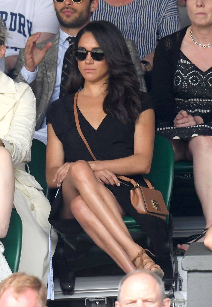 Meghan Markle in black dress sat watching the Wimbledon Tennis Championships  