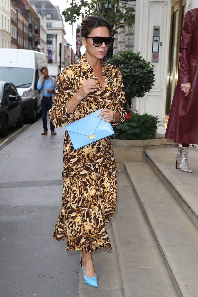 Victoria Beckham's accessories add a bold clash to her patterned dress