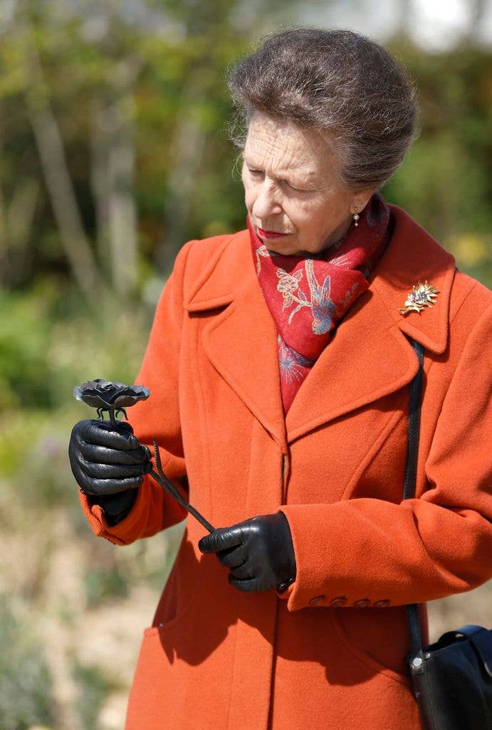 Princess Anne, Princess Royal is presented with a gilded metal flower crafted for the site during the official opening of The Queen Elizabeth II Garden in The Regentâs Park on the 100th anniversary of her mother's birth on April 21, 2026 in London, England
