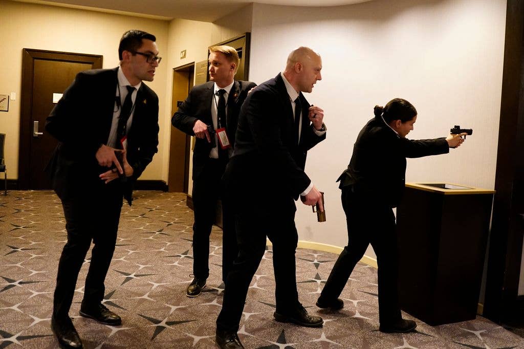 Federal agents draw their guns out after an incident at the annual White House Correspondents Association Dinner 