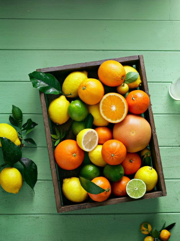 overhead view of citrus fruits in wooden tray box