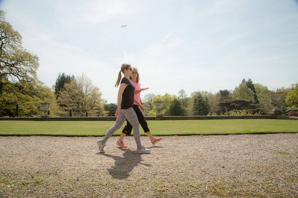 Two women walking in the sun in nature 