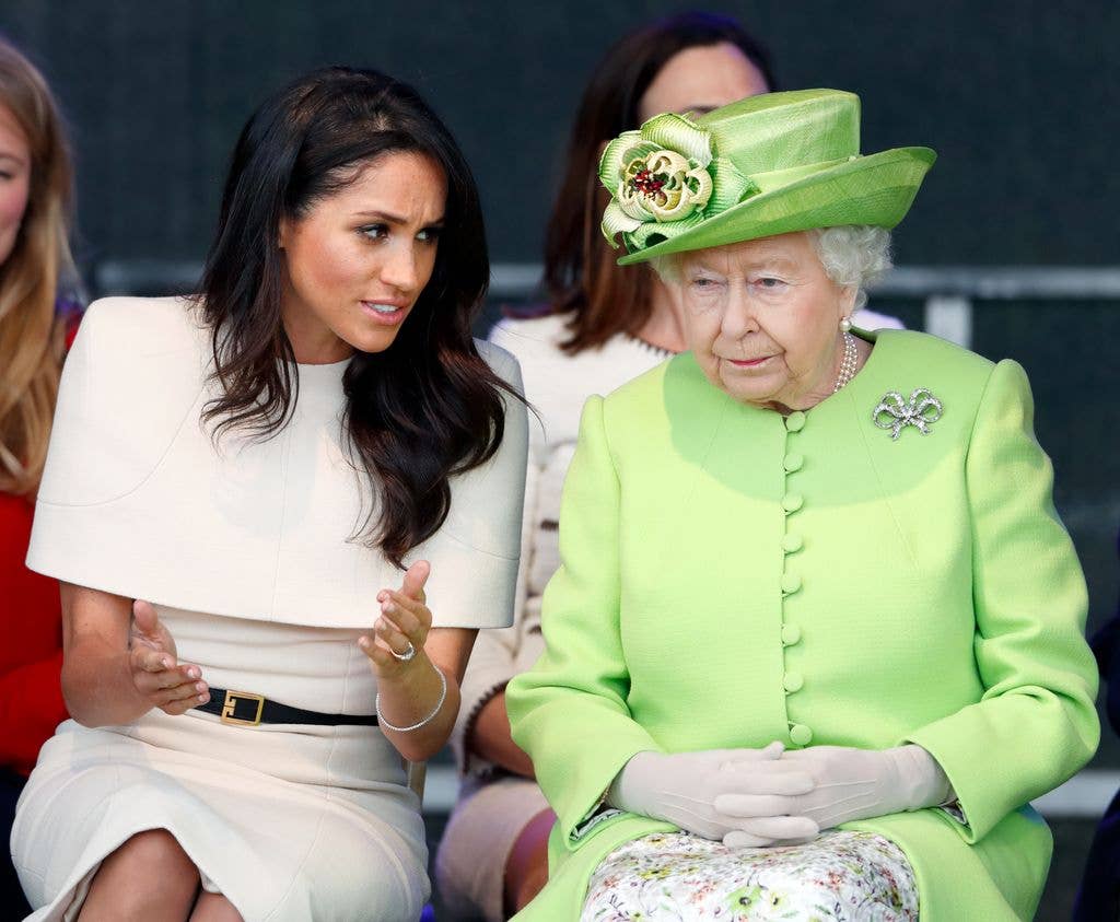 Meghan, Duchess of Sussex and Queen Elizabeth II in conversation seated