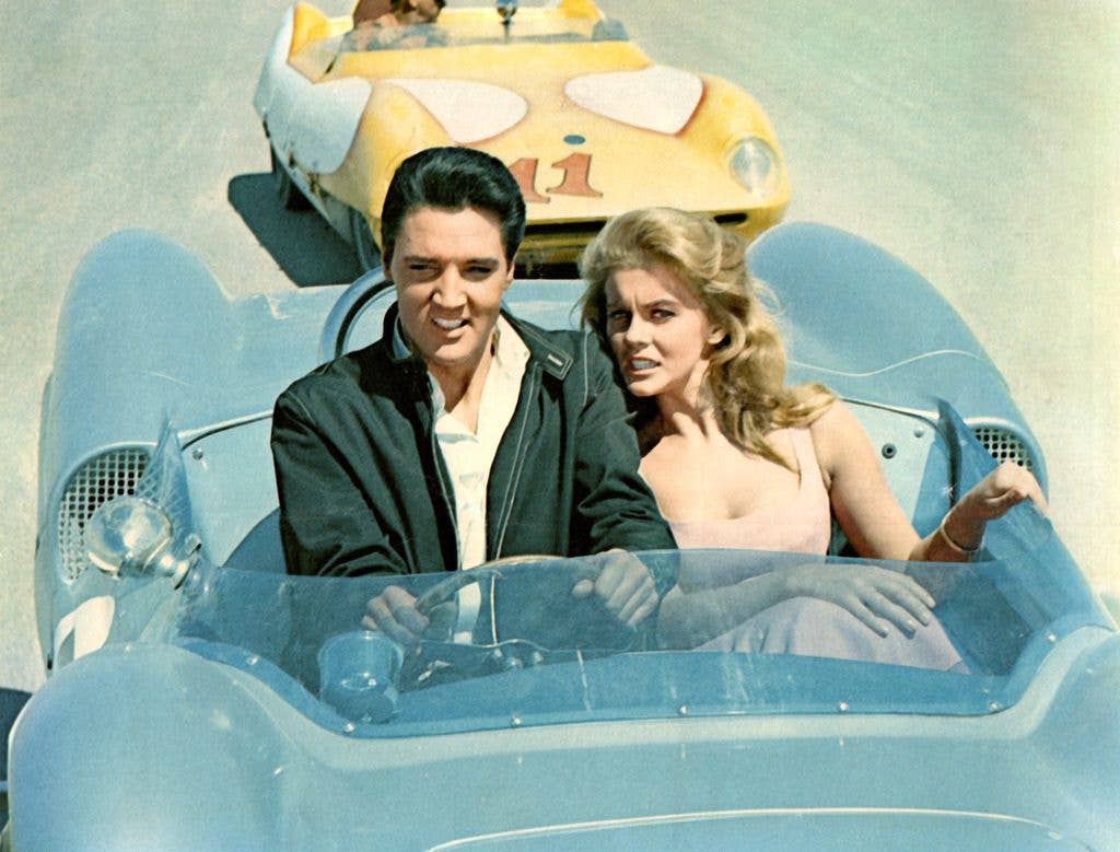 Elvis Presley and Ann-Margret driving in race car in scene from 'Viva Las Vegas' 1964