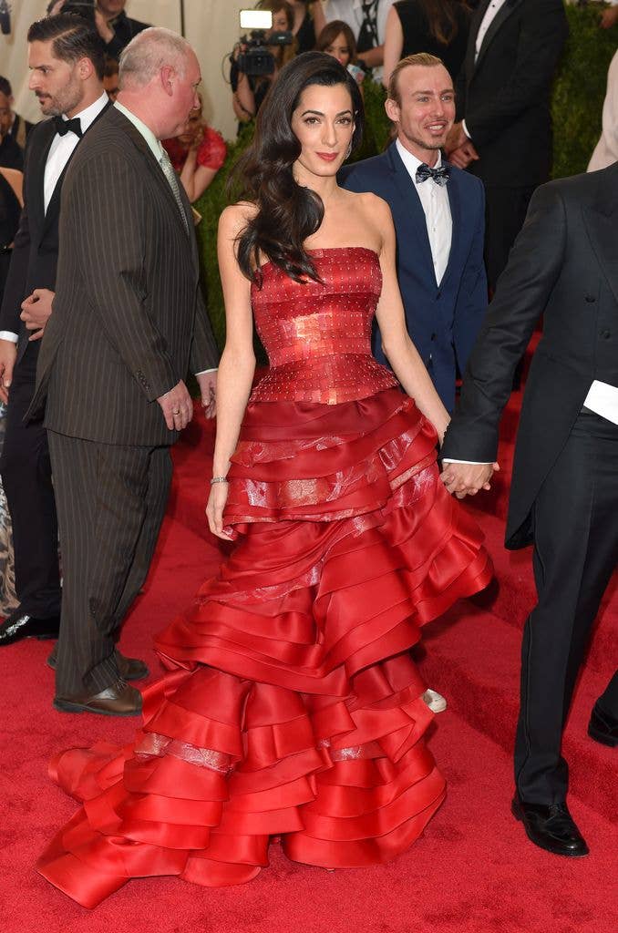 Amal Clooney in red  gown on red carpet