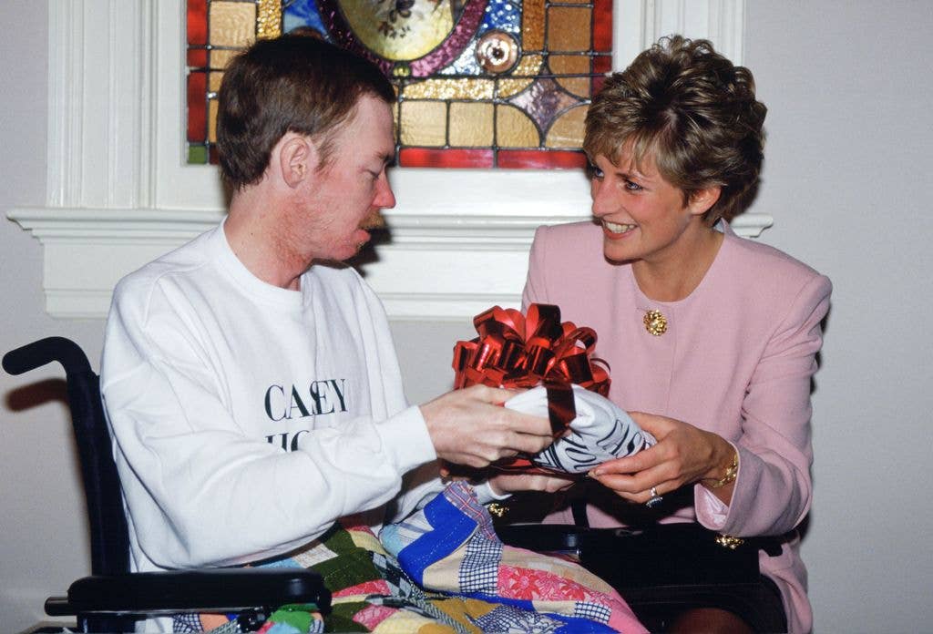 Princess Diana giving a present to a man with AIDS in a hospice