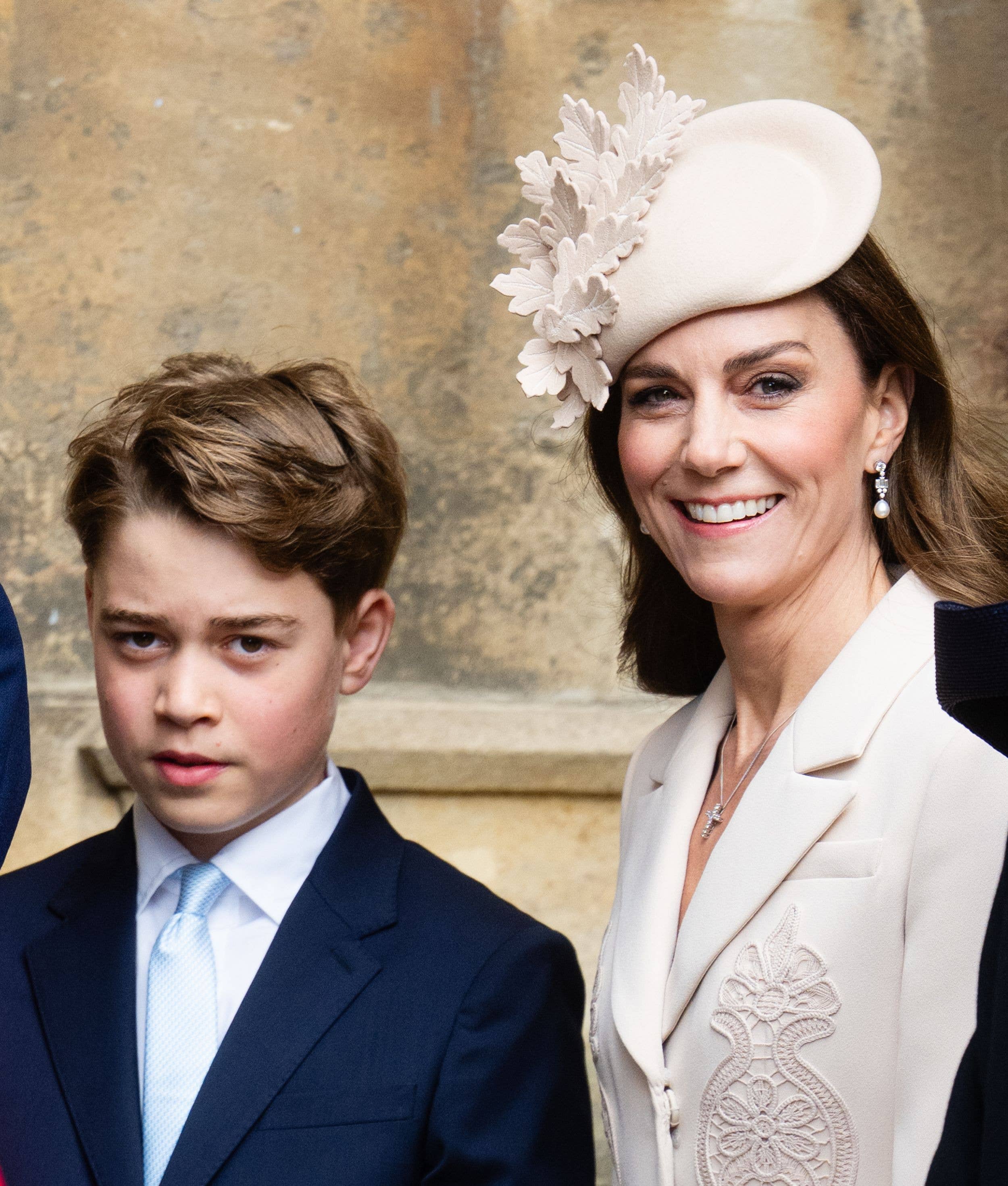 Prince George of Wales in suit and Catherine, Princess of Wales in white dress and hat 