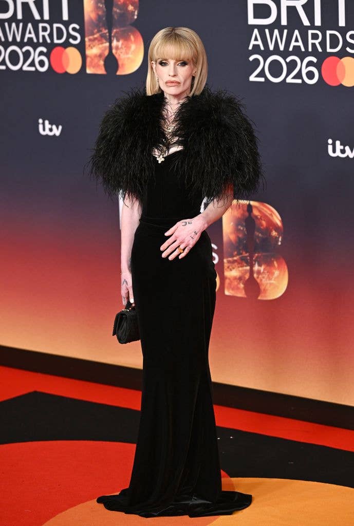 Kelly Osbourne in black dress on the red carpet at The BRIT Awards