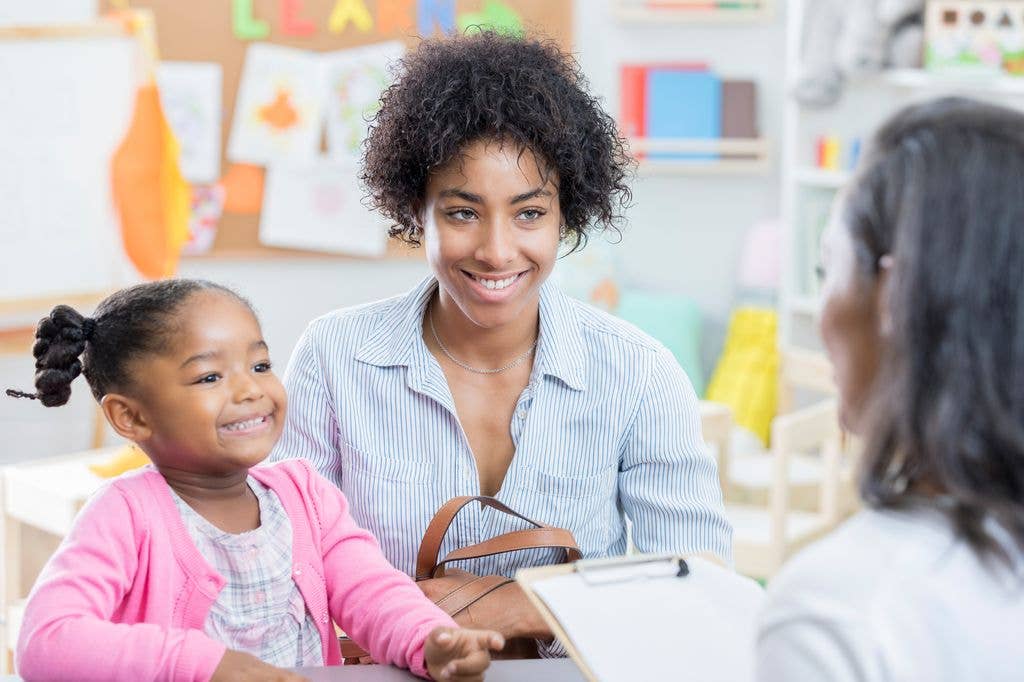 Mum and daughter talk to teacher