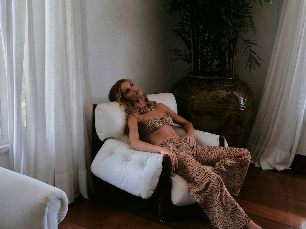 Rosie Huntington-Whiteley laying on a chair