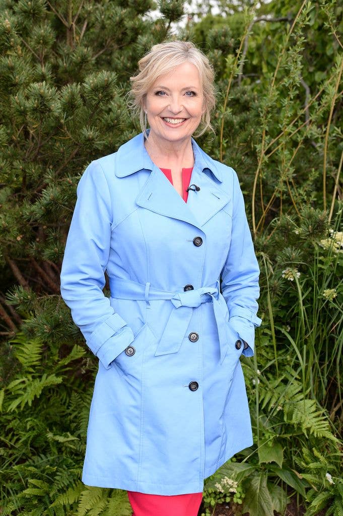 Carol Kirkwood in a baby blue coat and red dress
