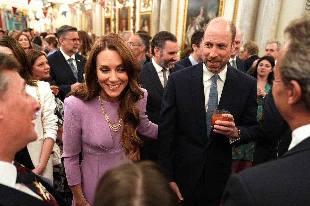 The Princess of Wales and Prince William talk with guests during a reception at Buckingham Palace