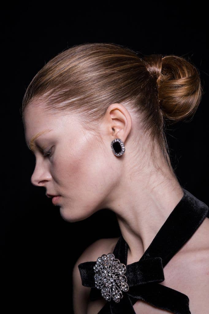 A model backstage with an updo done by Sam McKnight